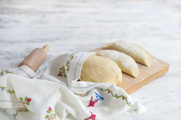 Homemade pies, cooking. Dough. A rolling pin and a towel with a pattern. Free space for text