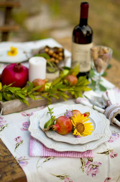 Lunch in the garden with wine and fruit. Romantic dinner in the open air. Autumn leaves of flowers. Beautiful table scrapbooking. — Stock Photo, Image