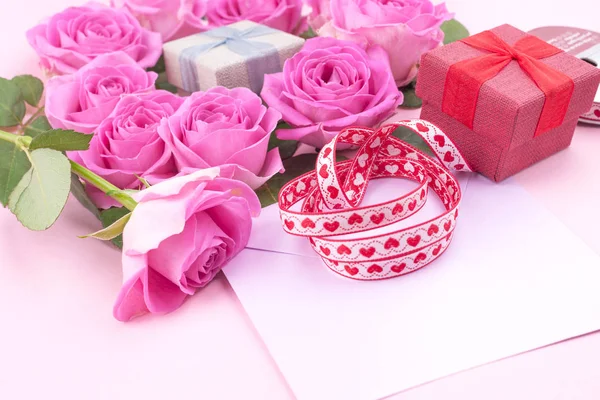 roses and envelope on a light background. Bouquet and letter as a gift in the concept of Valentine\'s Day or birthday. Free space for text