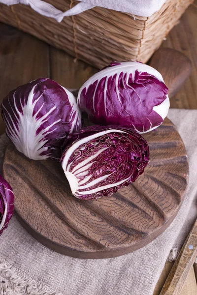 Ahşap bir masada kırmızı lahana ve karatahta. Vitaminli İtalyan salatası. Mutfakta yaşam tarzında sebzeler var. Metin için boş alan