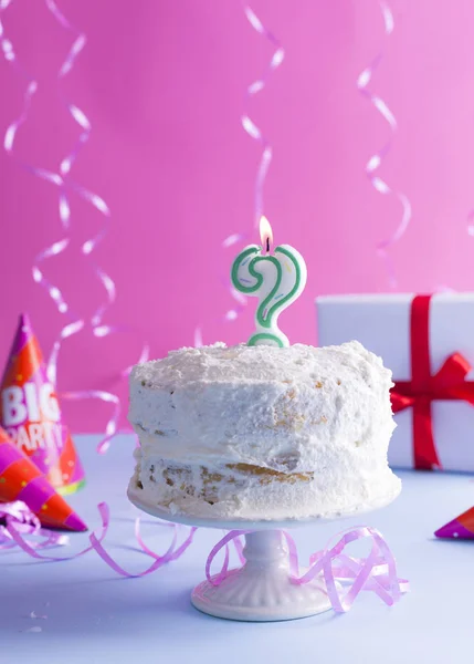 A festive sponge cake with white cream for a birthday, on a pink — Stock Photo, Image