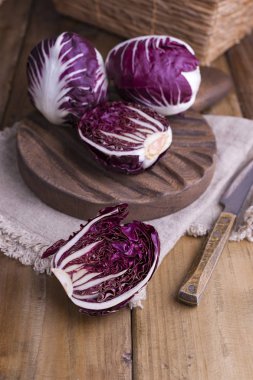 Ahşap bir masada kırmızı lahana ve karatahta. İtalyan salatası