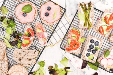 Beyaz ahşap bir masada yaz sandviçleri ve kuşkonmaz.. 