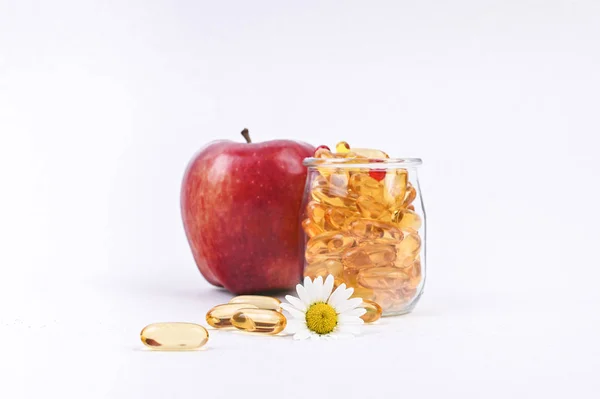 Pomme et vitamines en capsules sur fond blanc. Espace libre — Photo