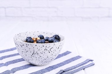 Beyaz arka planda yaban mersinli müsli. te için boş alan