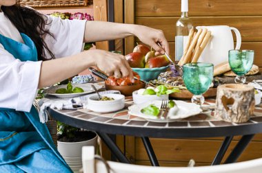 Kızarmış karides bir tava ile bir kız yemek masasında oturuyor