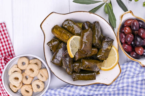 Türk lahana ruloları ve çeşitli ulusal mutfaklar. Üzüm yapraklı ve zeytinli pilav. Geleneksel doğu yemeği için yiyecek..