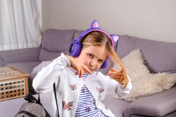 Little girl in musical headphones