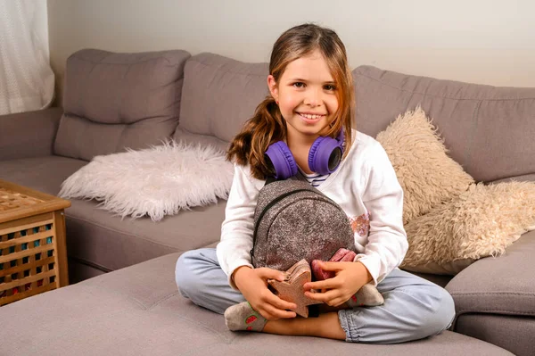 Little girl in musical headphones