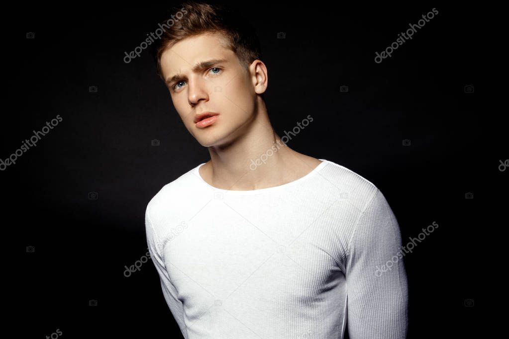 Male casual style guy in white sport suit on black background