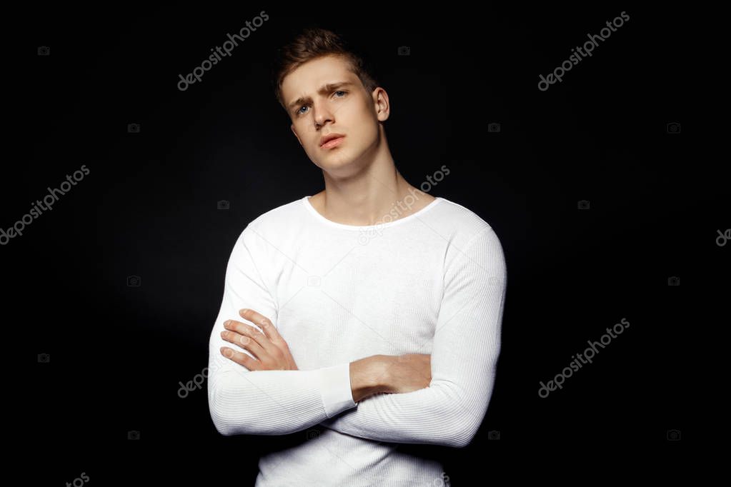 Male casual style guy in white sport suit on black background