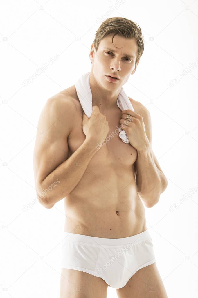 Strong stripped muscle male model in underwea on white isolated font background