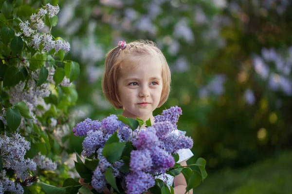 Clooseup かわいい肖像ライラックの花束を持つ少女 — ストック写真