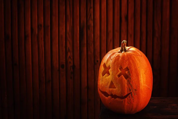 Halloween pumpkin on dark wooden background