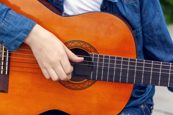 Joven sosteniendo una guitarra y tocando música . —  Fotos de Stock