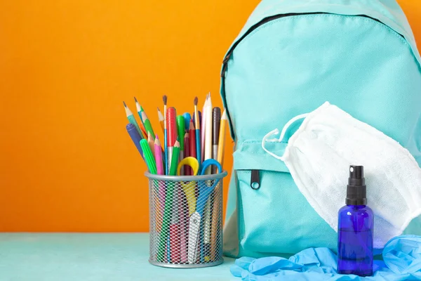 Blue School Backpack Mask Hand Sanitizer Gloves Stationery Table Orange — Stock Photo, Image