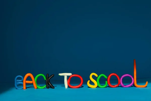 Creative back to school background on a blue background. The letters are grouped into the word BACK TO SCHOOL.