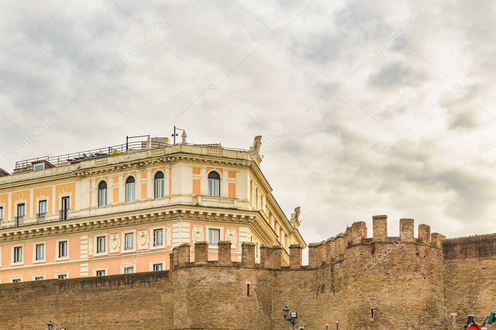 Low angle view of battlement wall and classical building at rome city, Italy