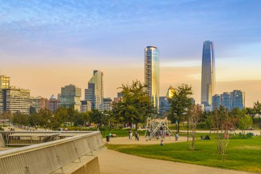 SANTIAGO DE CHILE, CHILE, MAY - 2018 - Bicentennial park and moderrn financial district at background in santiago de chile city. clipart