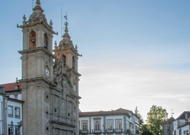 Braga, Portugal: August 14 2023: A vertical shot from a garden in Braga, Portugal, looking towards a historic church tower against the evening sky. 