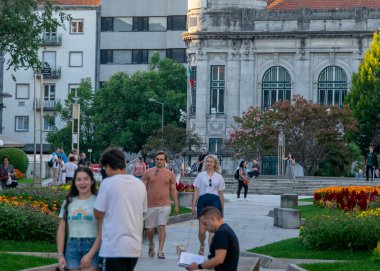Braga, Portugal: August 14 2023: A shot of people strolling through a plaza in the historic center of Braga, Portugal, on a sunny day. 