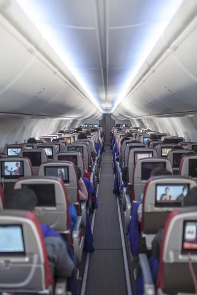 Passengers traveling by a new jet plane, shot from the inside of an airplane