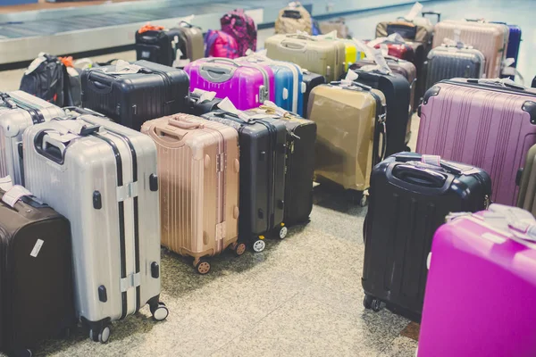 Wheeled suitcase on a luggage belt at the airport terminal.