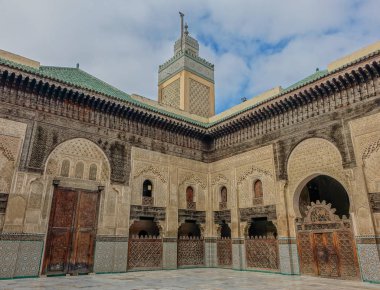 Fez, Fas, Afrika - 12 Şubat 2016: İç avlu ve Fez Al-Attarine Medresesi minare mavi gökyüzü altında