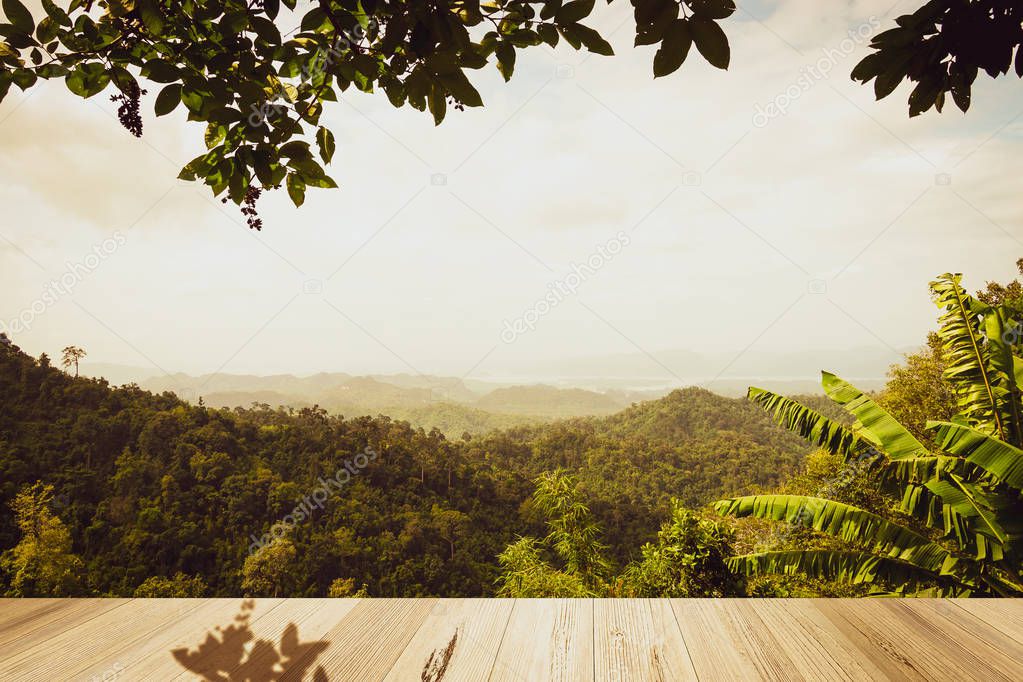 look at the wide beautiful view  forest in far of mountain,Thailand from near top wood table.