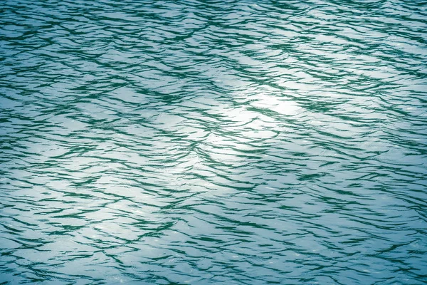 Beautiful pattern of blue water reflecting the sun.