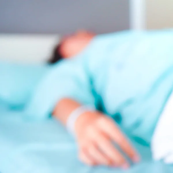 Blurred patient on bed in Hospital standard VIP room with beds and comfortable medical equipped