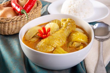 Yellow Curry Chicken on wooden table. clipart