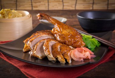 roasted duck on a wooden table background clipart