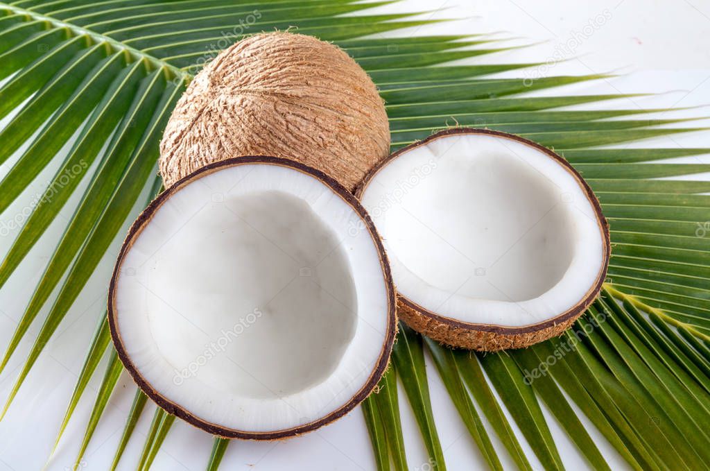 Coconut with milk  on coconut leaf background