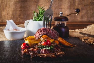 Biftek, sebze ve baharatlı kesim tahtası.