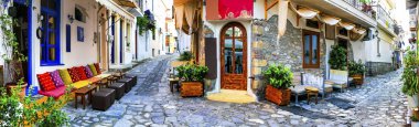 Traditional colorful Greece - charming old streets of Skiathos,view old doors and floral decoration. clipart