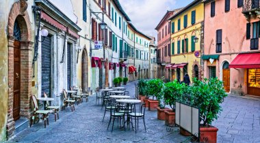 Charming streets with bars in narrows alleys of italian towns. Montalcino in Tuscany. Italy clipart