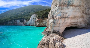 Greece best beaches of Ionian islands. Cephalonia (Kefalonia)- scenic desrted beach Fteris with tropical turquoise sea and white pebbles  clipart