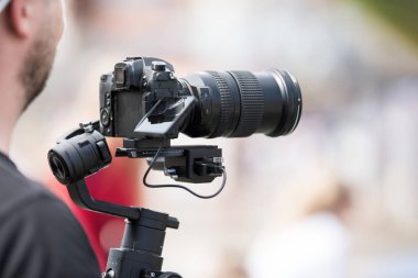 Siyah sabitleyici ile bir tripod ile bir kamera ile video çekim
