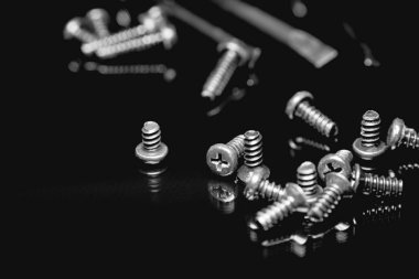 Koyu arka plan üzerinde siyah vidalar