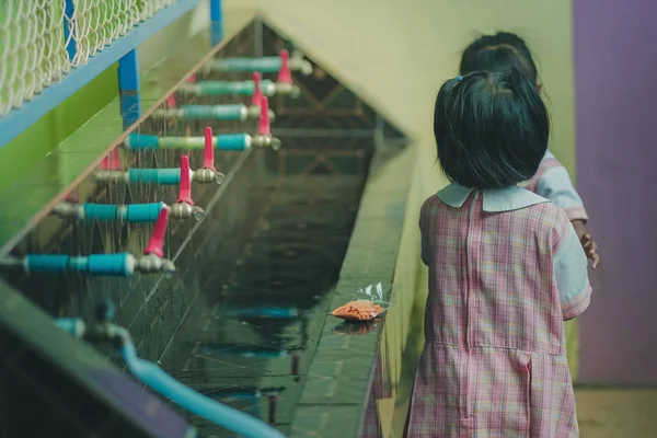 Öğrenciler içme suyu musluk öğle yemeğinden sonra.