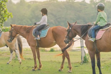 Gün batımından önce Nehri yakınında bir at binmeyi öğrenmek.