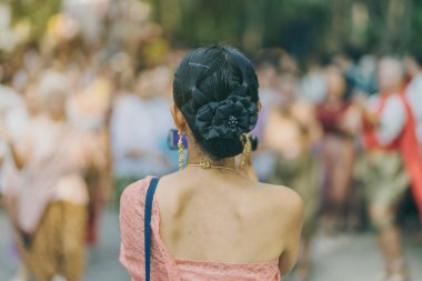 Back view of female in Thai dress  take a photo of a Thai dance parade in Songkran festival 