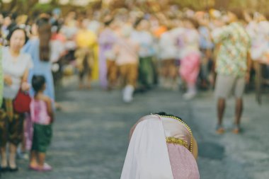 Back view of female in Thai dress  take a photo of a Thai dance parade in Songkran festival