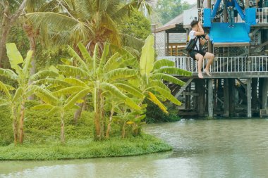 Pattaya Yüzen Pazar'da göl boyunca bir zipline aka uçan tilki uçan bir erkek turist