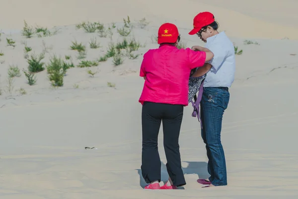 MUI NE, VIETNAM - 25 DE ABRIL: Turistas no identificados se relajan y toman fotos el 25 de abril de 2019 en el desierto de dunas de arena blanca — Foto de Stock
