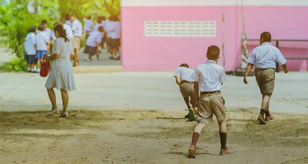 Vue arrière de l'enseignant et des élèves marchant vont étudier à la salle de classe dans le bâtiment — Photo