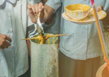 Öğrenciler Budist Lent günü için tapınağa erime dökme mum teklif katılmak,