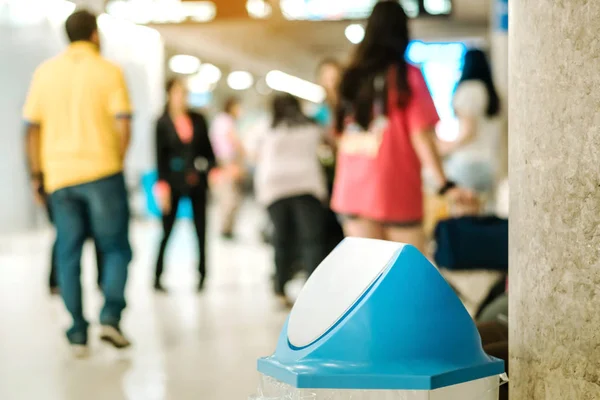 Blue cover transparent trashcan for increasing safety measures placed on the floor in the airport.