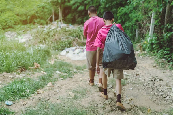 Estudiantes masculinos ayudan a eliminar la basura del aula para amontonar residuos — Foto de Stock